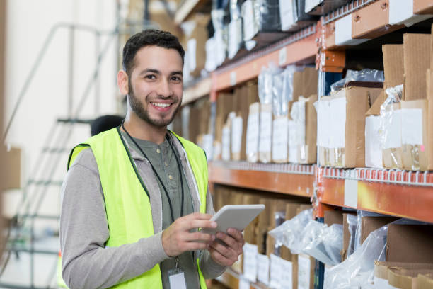 istock Confident warehouse employee works on customer's order 973984984