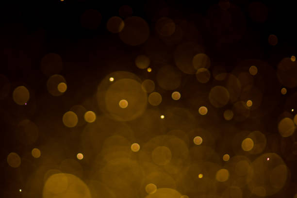 istock Abstract gold bokeh with black background 973985124