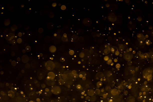 istock Abstract gold bokeh with black background 973985226