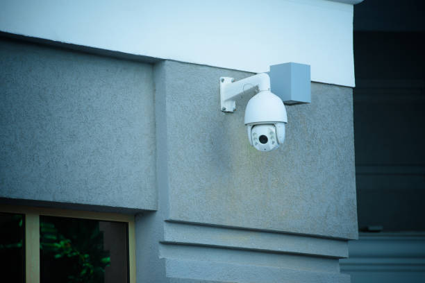 istock close up view of security camera on gray building facade 973988638