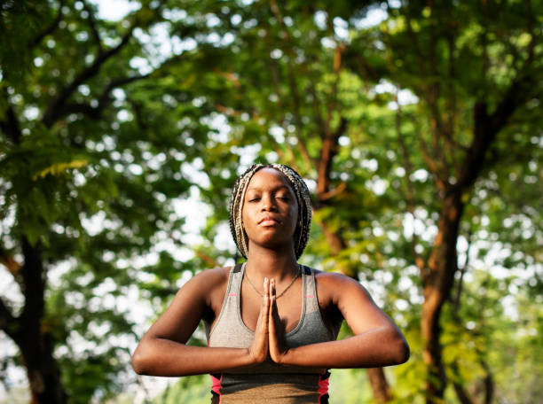 istock A woman doing yoga in the park 973990784