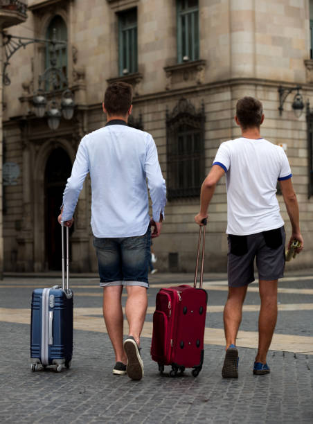 istock Rear view of two guys with luggage 973999408