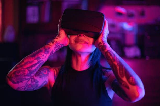 istock Young woman looks fascinated into Virtual Reality Headset 974003210