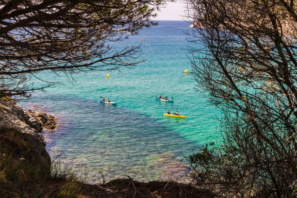 La Fosca beach with people practicing kayaking in Costa Brava, Girona, Catalonia, Spain