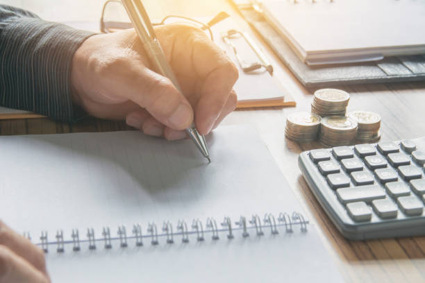 istock Businessman working and writing on notebook for business and accounting concept. 974010872