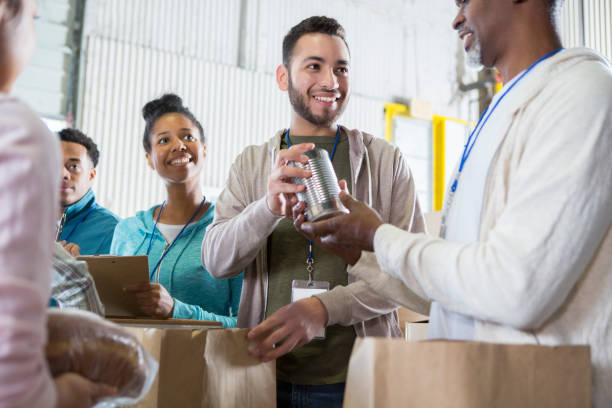 istock Food bank volunteers sort through donations 974017550