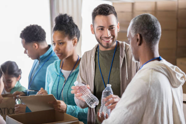 istock Man donates water during food drive 974017844