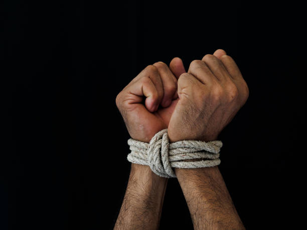 istock Man hands were tied with a rope. Violence, Terrified, Human Rights Day concept. 974024728