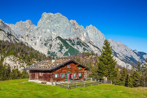 Snowy mountain huts on the Seiser Alm, Dolomites, South Tyrol, North Italy. In the backround the Langkofel and Plattkofel.