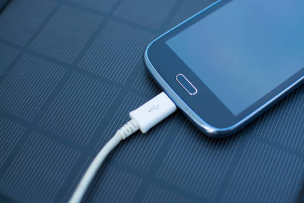 istock Mobile phone charging with solar energy - charger 974031086