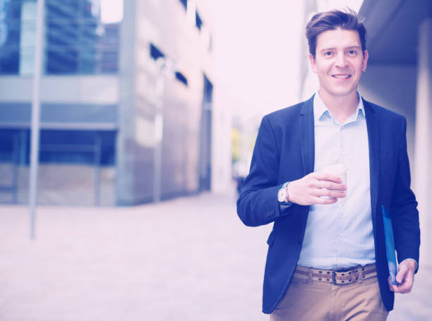istock Portrait of cheerful male with documents 974031236