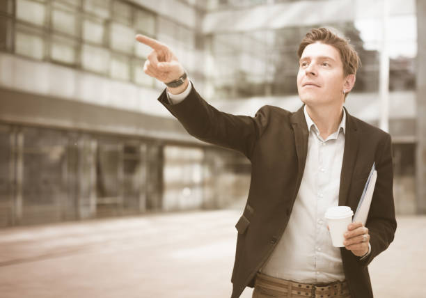 istock Smiling businessman with cup of coffee 974031392
