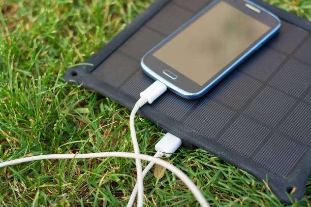 istock Mobile phone charging with solar energy - charger 974038490