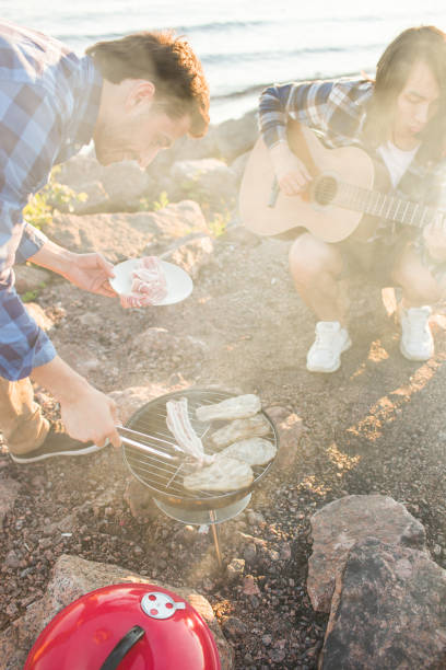 istock People grilling meat on picnic 974046984