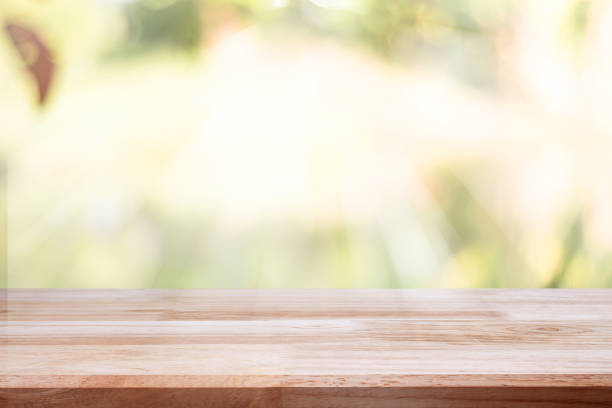 istock empty wooden on blurred nature backdrop. Wood table top. can used for display or montage your products 974053356