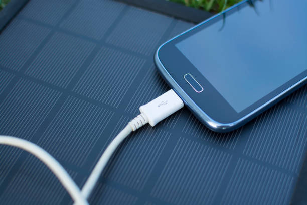 istock Mobile phone charging with solar energy - charger 974056714