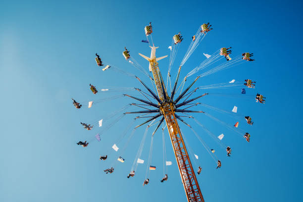 people enjoy the ride on a chairoplane, oktoberfest, munich, germany - amusement park oktoberfest munich chain swing ride imagens e fotografias de stock