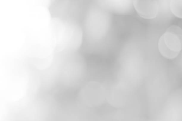 istock white blurred backdrop of nature, circle white wallpaper, gray bokeh background 974084004