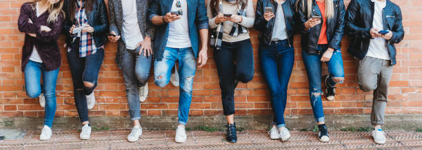 istock Group of friends using smartphone outdoors 974087198