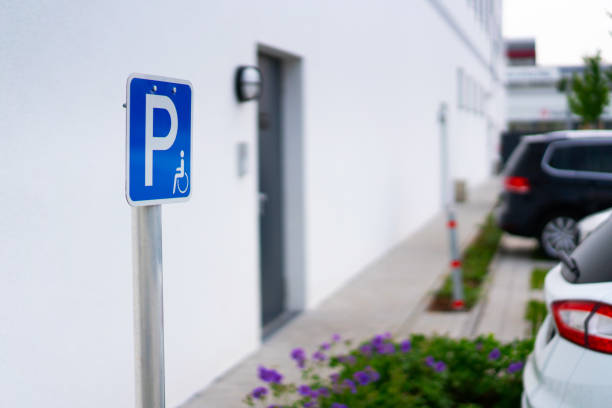 istock blue disabled parking badge with white wall background 974090018