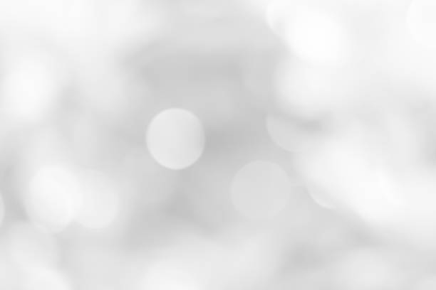 istock white blurred backdrop of nature, circle white wallpaper, gray bokeh background 974091030