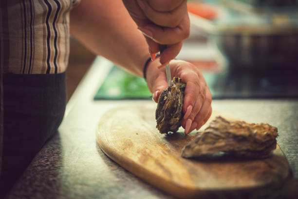 istock Young Women Preparing Fresh Oysters 974093378