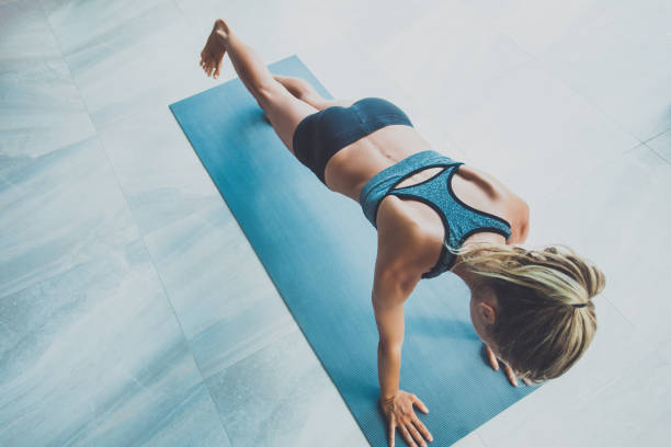 istock Sporty woman doing exercise in a gym 974093392