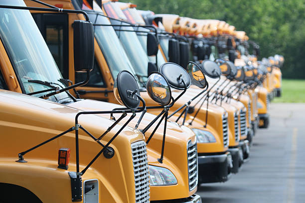 istock Yellow School Buses Parked in Line with Multiple Safety Mirrors 97409356