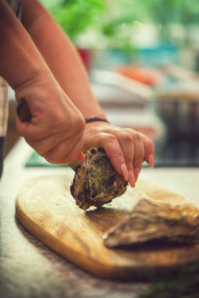 istock Young Women Preparing Fresh Oysters 974095740