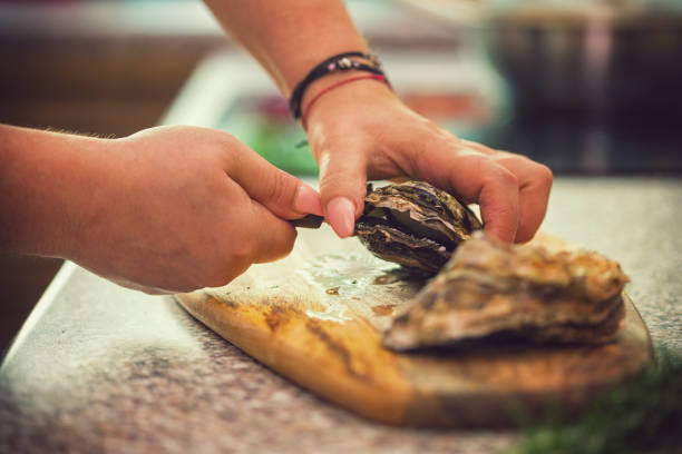 istock Young Women Preparing Fresh Oysters 974095818