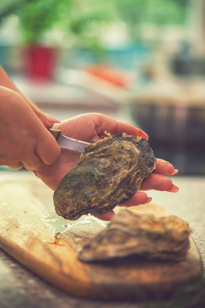 istock Young Women Preparing Fresh Oysters 974100324
