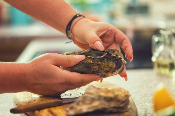 istock Young Women Preparing Fresh Oysters 974100966