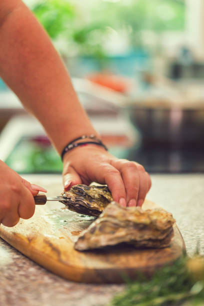 istock Young Women Preparing Fresh Oysters 974102456
