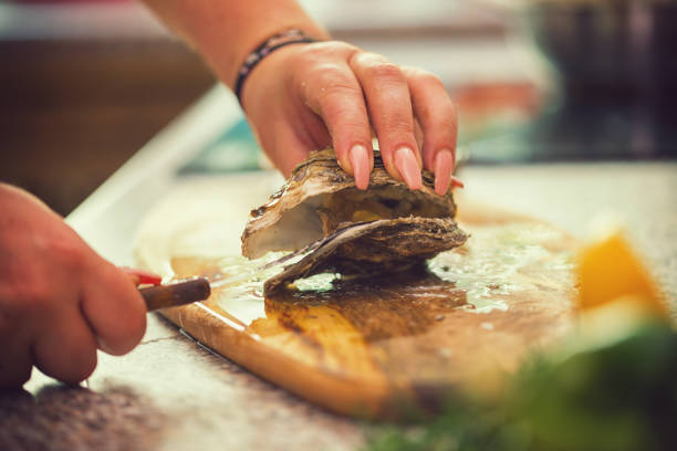 istock Young Women Preparing Fresh Oysters 974102714
