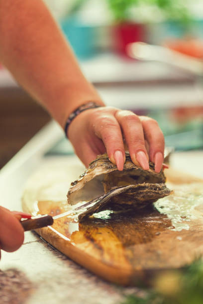 istock Young Women Preparing Fresh Oysters 974107076