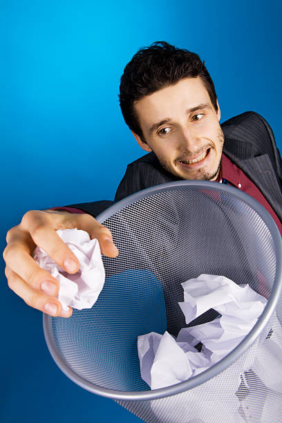 istock Young businessman playing baskteball with crumpled paper 97410754