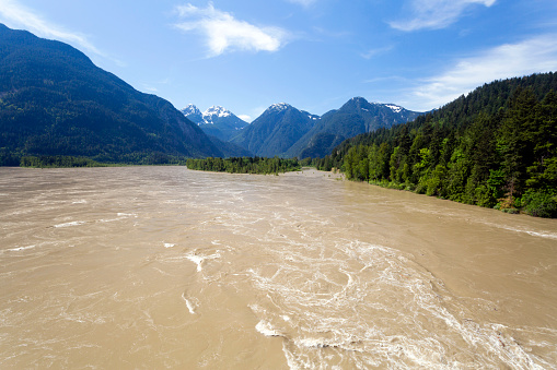 Rapids in the springtime flowing water of the Fraser River in Hope, British Columbia, Canada.