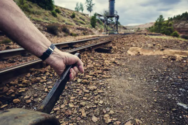 Photo of Hand pulling the lever to change the way in the old train station of Zaranda