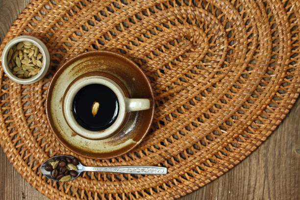 istock Brown cup of black coffee with cardamom, flat lay 974140356