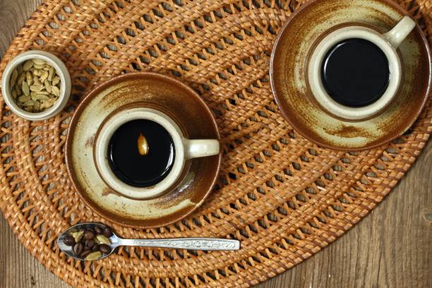 istock Brown cup of black coffee with cardamom, flat lay 974142086