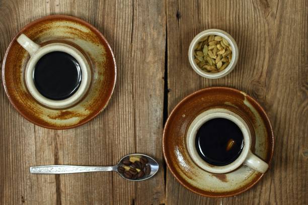 istock Brown cup of black coffee with cardamom, flat lay 974142182