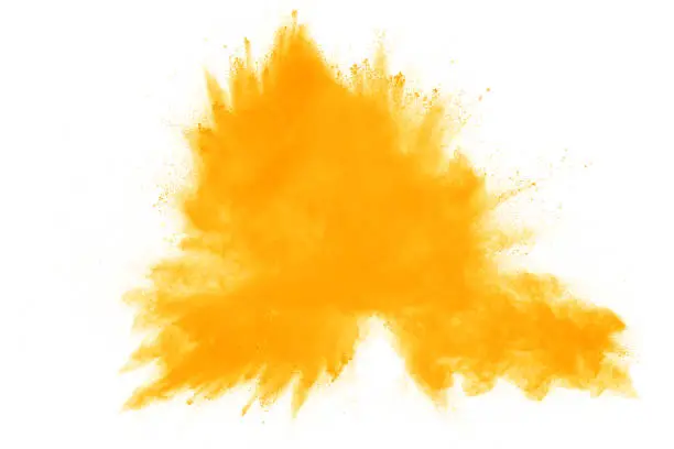 Photo of abstract yellow dust explosion on  white background. abstract yellow powder splatter on white background. Freeze motion of yellow powder splash.