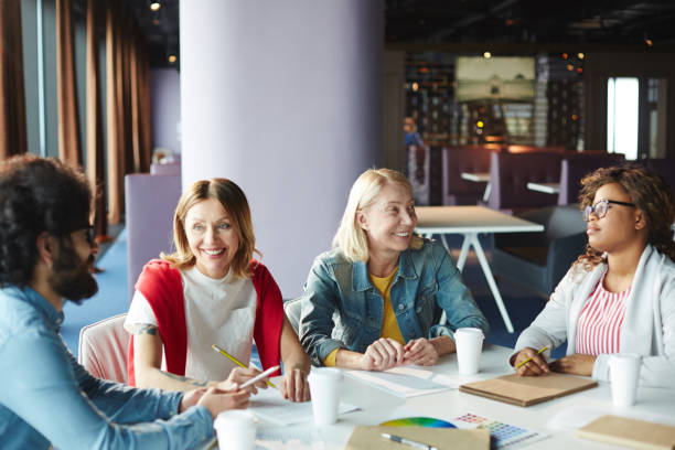 istock Excited creative colleagues laughing at meeting 974152992