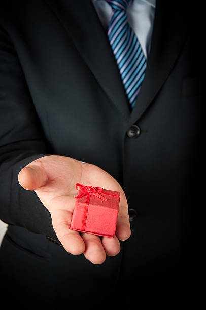 istock Businessman holding a small  red gift box 97415589