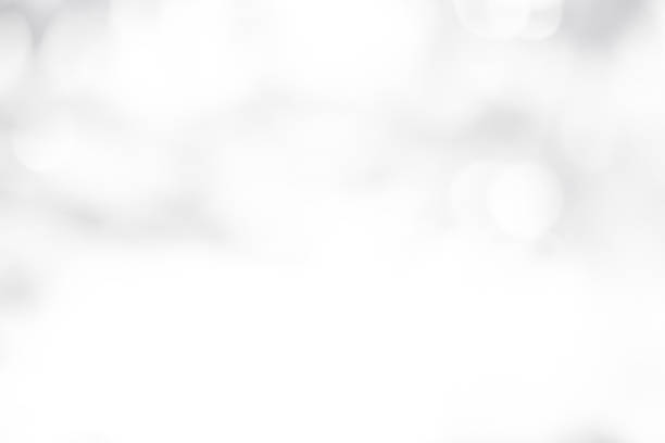 istock white blurred backdrop of nature, circle white wallpaper, gray bokeh background 974156750
