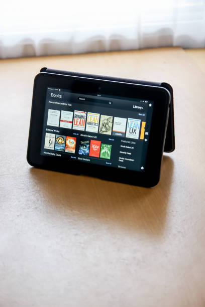 istock An Isolated Open Kindle on a Wooden Table 974158672