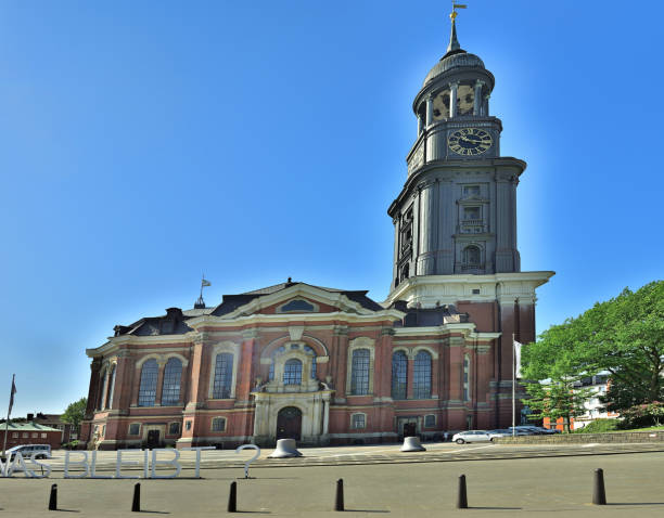 St. Michael's Church (Hauptkirche Sankt Michaelis), colloquially called Michel, is one of Hamburg's five Lutheran main churches (Hauptkirchen) and the most famous church in the city. St. Michaelis is a landmark of the city and it is considered to be one of the finest Hanseatic Protestant baroque churches. The church was purposely built Protestant unlike many other Hamburg churches which were originally built by Roman Catholics and were converted to Protestantism during the Reformation. It is dedicated to the Archangel Michael. A large bronze statue, standing above the portal of the church shows the archangel conquering the devil.\n\nThe 132-meter high Baroque spire totally covered with copper is a prominent feature of Hamburg’s skyline and has always been a landfall mark for ships sailing up the river Elbe.