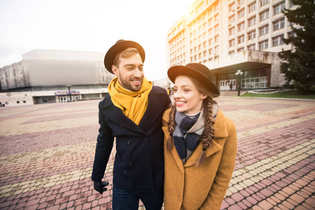 istock cheerful attractive young couple walking on street 974161262