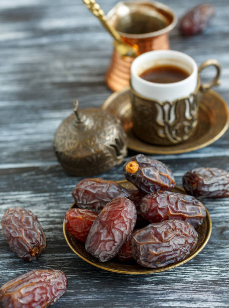 istock Dates on the plate, copper cezve and black coffee. 974175742