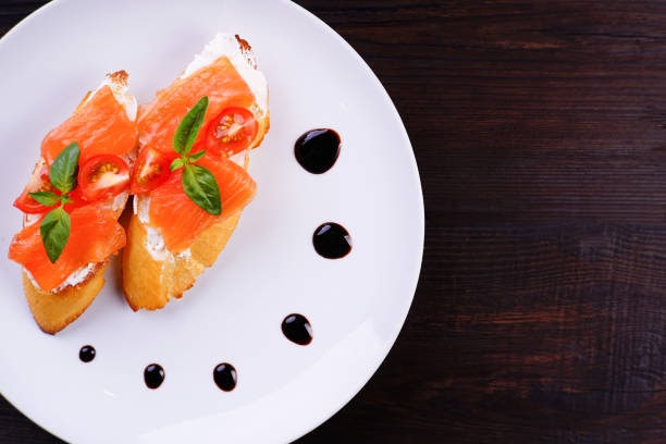 istock Appetizing crunchy Italian bruschettas with salmon 974181564